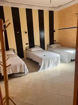 a room with two beds in a room at Dream Merzouga Rooms in Merzouga