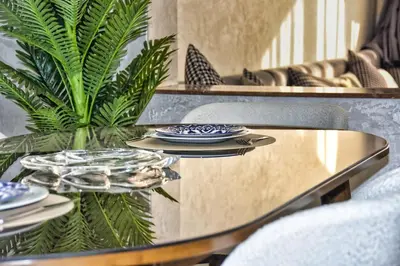 a table with plates on it next to a plant at Sunny get away in Agadir, Balcony and View in Oulad Akkou