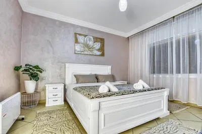 a bedroom with a large white bed and a window at Sunny get away in Agadir, Balcony and View in Oulad Akkou