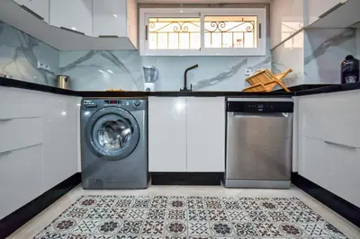 a kitchen with a washing machine and a sink at Sunny get away in Agadir, Balcony and View in Oulad Akkou