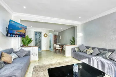 a living room with two couches and a table at Sunny get away in Agadir, Balcony and View in Oulad Akkou