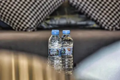 two bottles of water sitting on top of a table at Sunny get away in Agadir, Balcony and View in Oulad Akkou