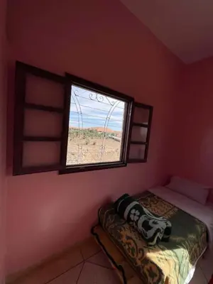 a bedroom with a window and a bed in it at Sahara desert Maison in Merzouga
