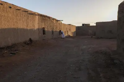 a person standing next to a brick wall at La Casa De GanGa in Khamliya