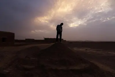 a man standing on top of a pile of dirt at La Casa De GanGa in Khamliya