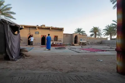 a group of people standing in front of a building at La Casa De GanGa in Khamliya