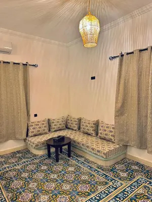 a living room with a couch and a table at riad tighmart in Merzouga