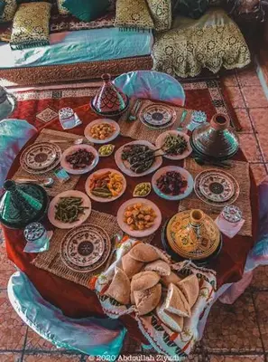 a table with plates of food on top of it at casa medina sanaa in Oulad Akkou