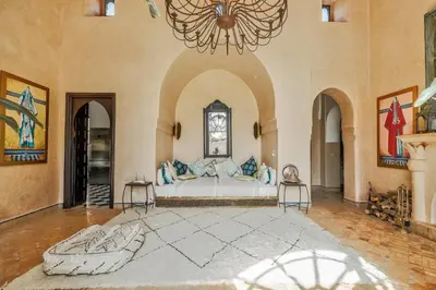 a large room with a bed and a chandelier at Villa l'Aziza in Najem