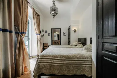 a bedroom with a bed and a large window at Villa l'Aziza in Najem