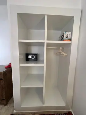 a white book shelf with a radio in it at Modern accommodation with Riad spirit in Hivernage in Oulad Akkou