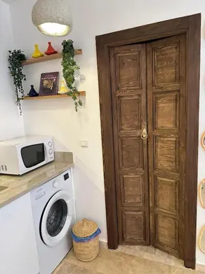 a kitchen with a washing machine and a microwave at Modern accommodation with Riad spirit in Hivernage in Oulad Akkou