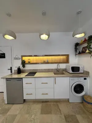 a kitchen with a sink and a washing machine at Modern accommodation with Riad spirit in Hivernage in Oulad Akkou