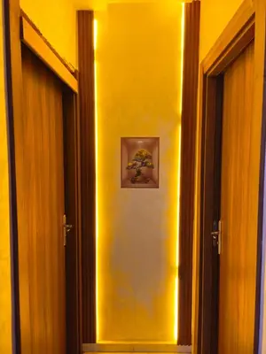 a hallway with two doors and a picture on the wall at CONFORT HOMe in Oulad Akkou