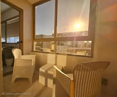 a room with chairs and a table and a window at CONFORT HOMe in Oulad Akkou