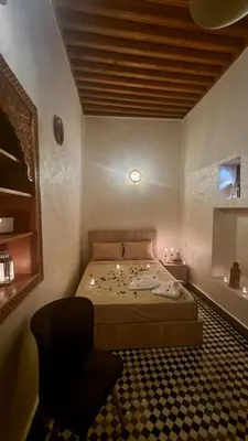a bedroom with a bed and a chair in it at Dar Boueden - lala hadhoum- Guest House in Fès