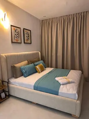 a bedroom with a bed with pillows on it at Studio haut-standing centre-ville parking-gratuit in Fès