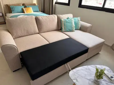 a couch with pillows on it in a living room at Studio haut-standing centre-ville parking-gratuit in Fès