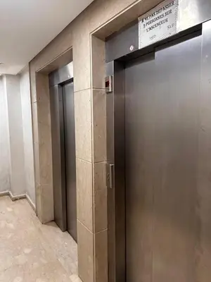 a row of elevator doors in a building at Studio haut-standing centre-ville parking-gratuit in Fès