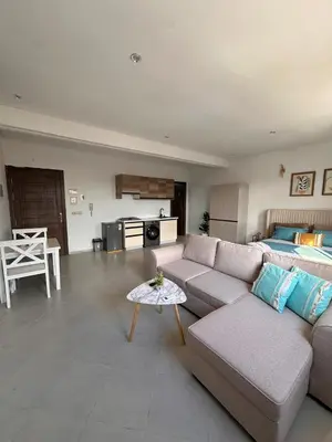 a living room with a couch and a bed at Studio haut-standing centre-ville parking-gratuit in Fès