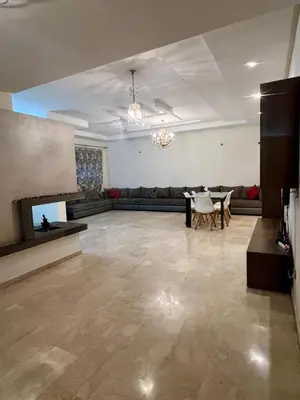 a large living room with a table and a fireplace at Moderne et spacieux appartement avec une belle vue - Espace Rihab centre ville in Fès