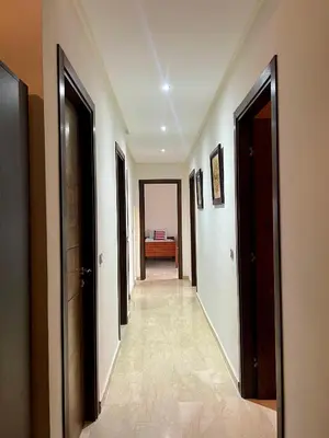 a hallway with doors and a room with a couch at Moderne et spacieux appartement avec une belle vue - Espace Rihab centre ville in Fès