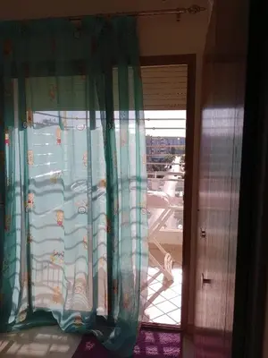 a window with curtains with a view of a street at Moderne et spacieux appartement avec une belle vue - Espace Rihab centre ville in Fès
