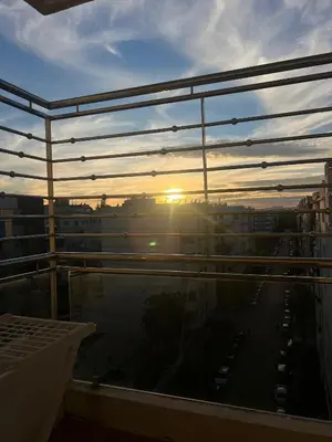 a view of the sunset from the balcony of a building at Moderne et spacieux appartement avec une belle vue - Espace Rihab centre ville in Fès