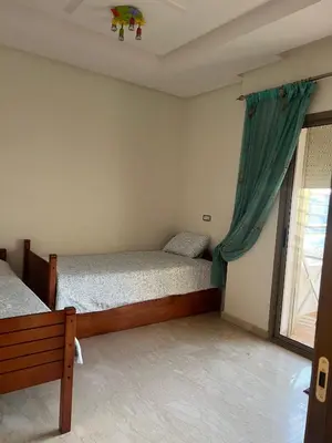 a bedroom with two beds and a window at Moderne et spacieux appartement avec une belle vue - Espace Rihab centre ville in Fès
