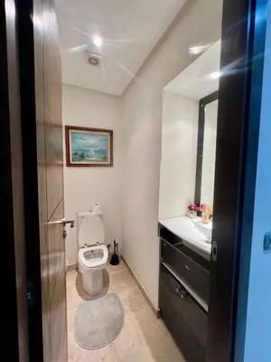 a bathroom with a toilet and a sink at Moderne et spacieux appartement avec une belle vue - Espace Rihab centre ville in Fès