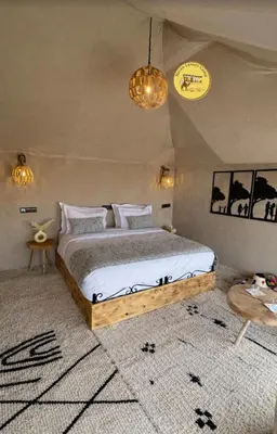a bedroom with a large bed in a room at Haven Luxury Camp in Merzouga