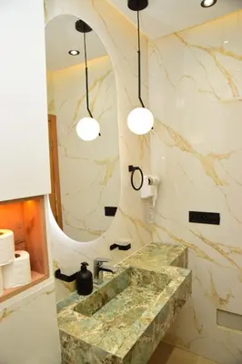 a bathroom with a marble sink and a mirror at Stylish & Cozy Apartment with Modern Design in Beni Mellal