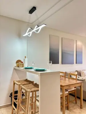 a kitchen and dining room with a table and chairs at Le murmure in Oulad Akkou