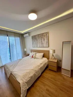 a bedroom with a large bed and a large window at Le murmure in Oulad Akkou