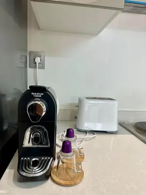a toaster sitting on a kitchen counter next to a toaster at Le murmure in Oulad Akkou