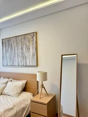 a bedroom with a bed and a mirror at Le murmure in Oulad Akkou