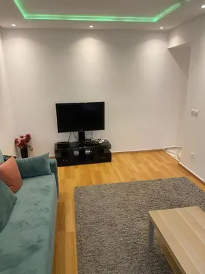 a living room with a couch and a flat screen tv at Miloche home in Oulad Akkou