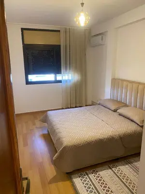 a bedroom with a large bed and a window at Miloche home in Oulad Akkou
