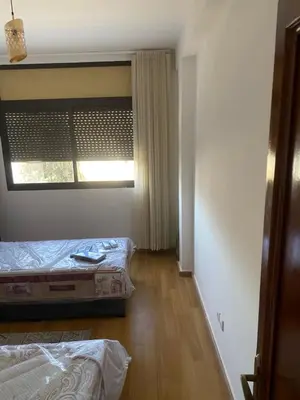 a room with two beds and a window in it at Miloche home in Oulad Akkou