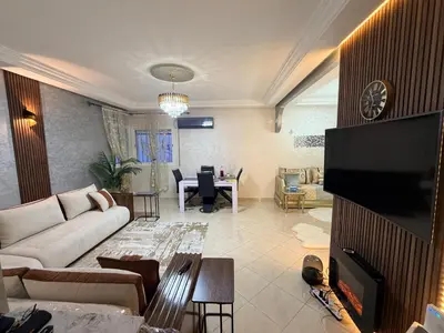 a living room with a couch and a table at Appartement in Meknès