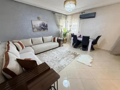 a living room with a couch and a table at Appartement in Meknès
