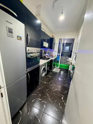 a kitchen with a refrigerator and a washer and dryer at Appartement in Meknès