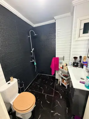 a bathroom with a toilet and a sink at Appartement in Meknès