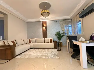 a living room with a couch and a desk at Appartement in Meknès