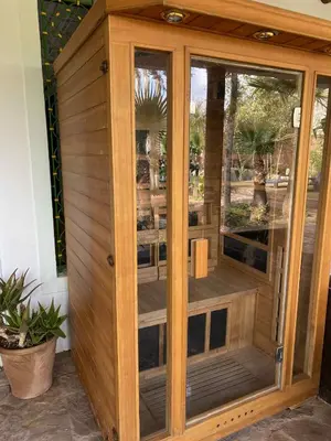 a wooden room with a wooden door with windows at Chambre dans un magnifique petit riad avec piscine in Aghmat