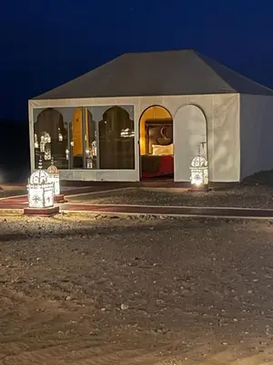 a tent in the middle of the desert at night at Merzouga luxury tente in Merzouga