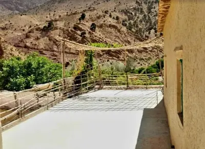 a tennis court with a mountain in the background at GÎTE D'ETAPE Tighanimin Tarhalt
