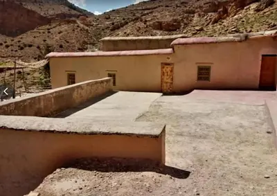 a building in the middle of a mountain at GÎTE D'ETAPE Tighanimin Tarhalt