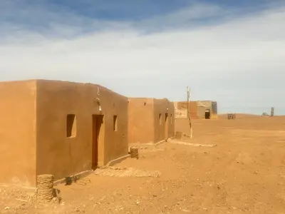 a building in the middle of the desert at Bivouac Porte du Désert in Mhamid