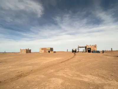 a dirt road in the middle of the desert at Bivouac Porte du Désert in Mhamid